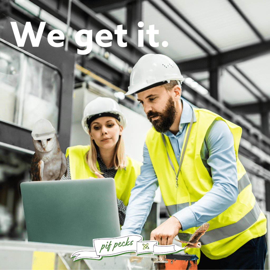 Two manufacturing professionals in high-visibility vests and hard hats reviewing data on a laptop, with Partnership Invoice Finance. Funding solutions for manufacturing companies.